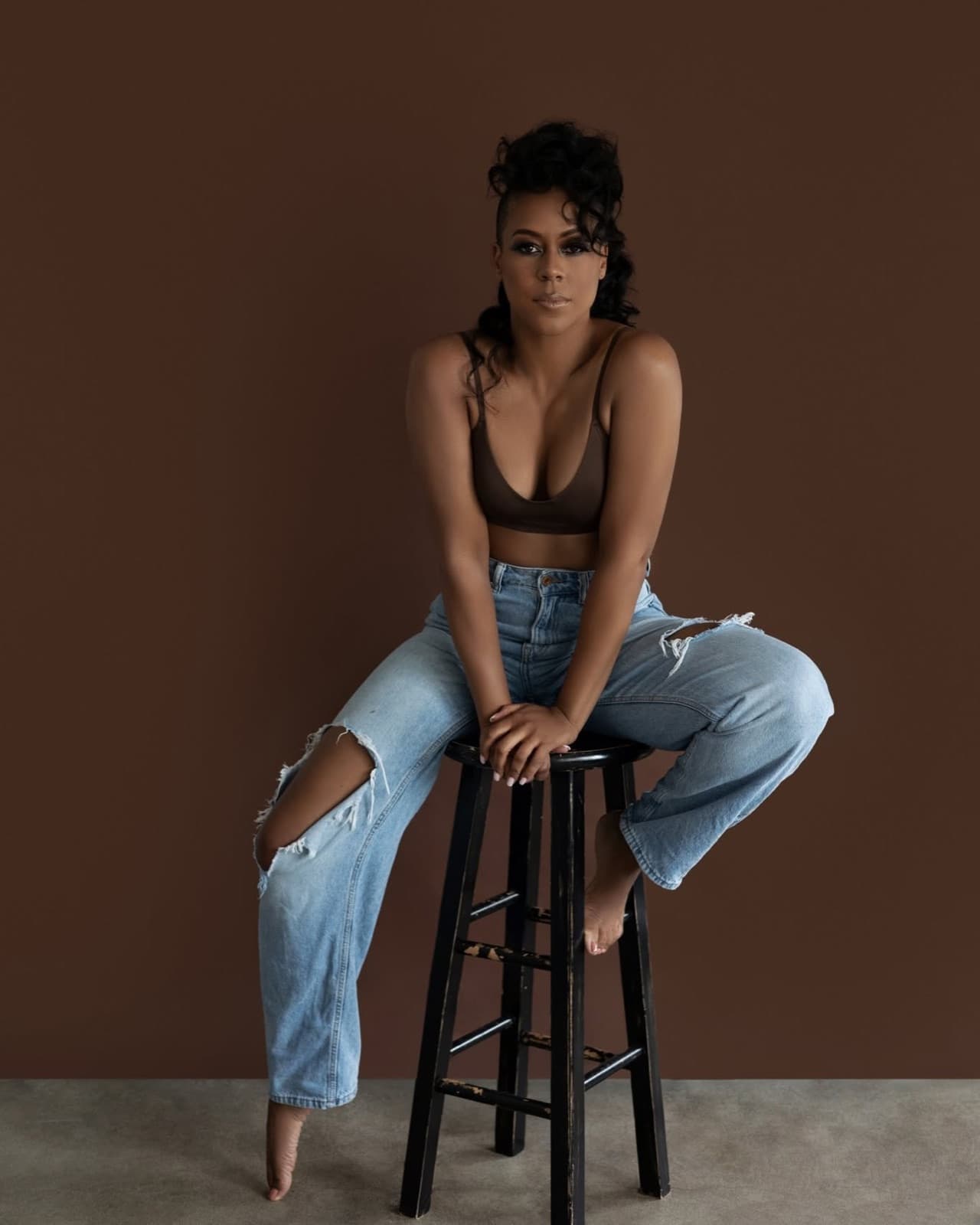 Lisa Ramey seated on a stool